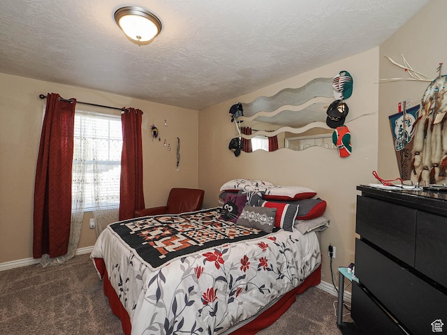 carpeted bedroom with baseboards and a textured ceiling