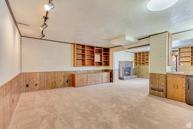 kitchen with light carpet, wainscoting, wallpapered walls, and wood walls