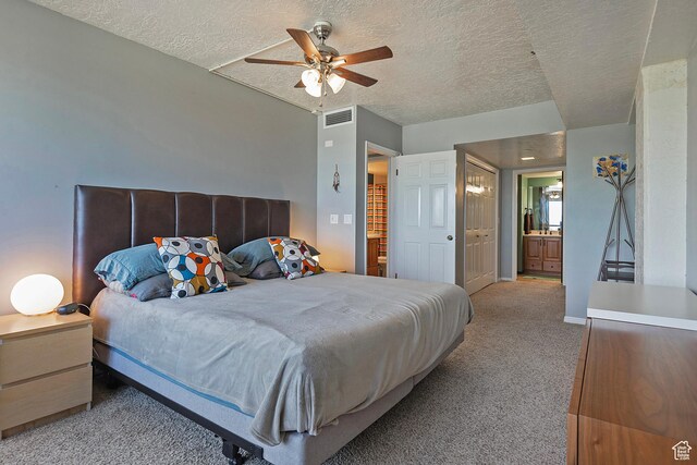 3125 E Kennedy Dr S Unit 605, Salt Lake City, UT 84108 - bedroom featuring connected bathroom, carpet, a textured ceiling, and visible vents