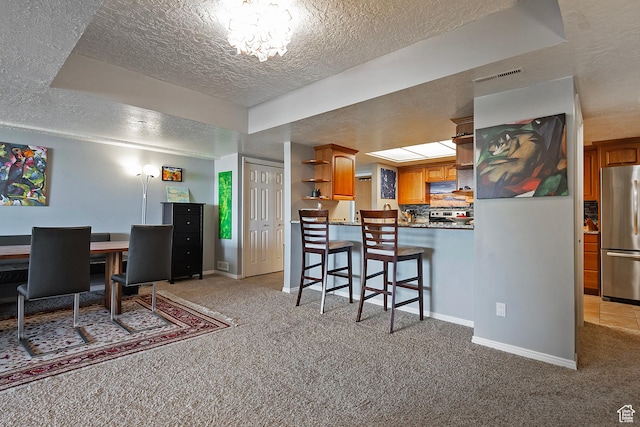 3125 E Kennedy Dr S Unit 605, Salt Lake City, UT 84108 - dining area with baseboards, a textured ceiling, visible vents, and light colored carpet