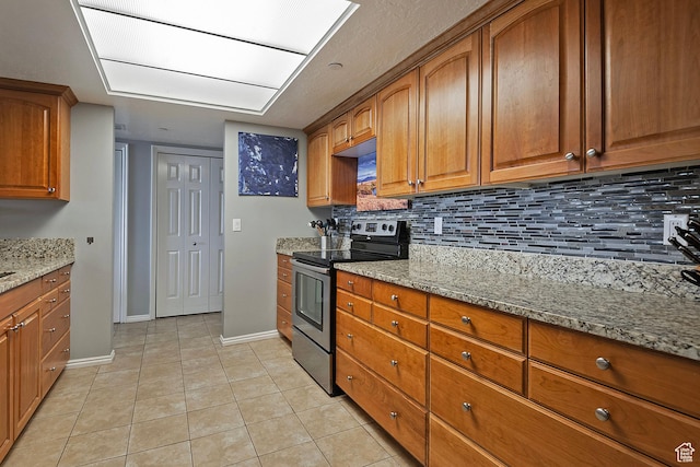 3125 E Kennedy Dr S Unit 605, Salt Lake City, UT 84108 - kitchen with decorative backsplash, brown cabinets, light stone counters, and stainless steel electric range
