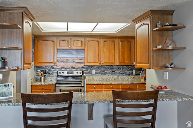 3125 E Kennedy Dr S Unit 605, Salt Lake City, UT 84108 - kitchen featuring light stone countertops, open shelves, tasteful backsplash, and stainless steel electric range