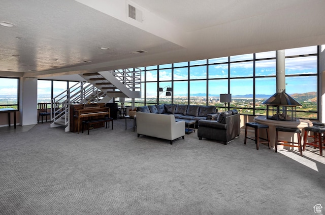 3125 E Kennedy Dr S Unit 605, Salt Lake City, UT 84108 - living area featuring plenty of natural light, visible vents, stairway, and carpet