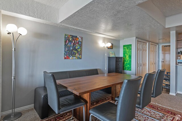 3125 E Kennedy Dr S Unit 605, Salt Lake City, UT 84108 - dining area with carpet, baseboards, and a textured ceiling