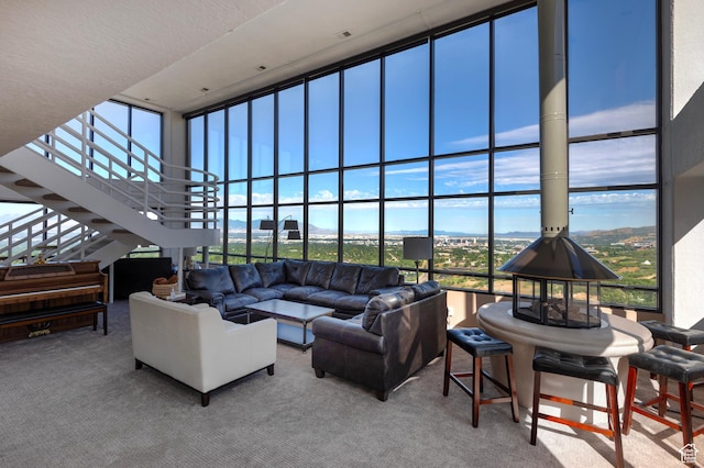 3125 E Kennedy Dr S Unit 605, Salt Lake City, UT 84108 - carpeted living area featuring a high ceiling and stairway