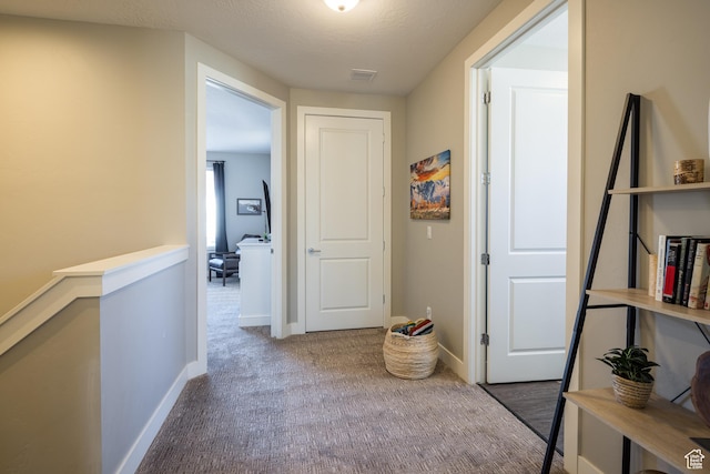 429 N 600 W, Moab, UT 84532 - corridor featuring baseboards, a textured ceiling, an upstairs landing, and carpet