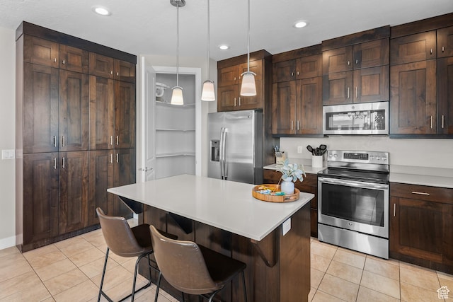 429 N 600 W, Moab, UT 84532 - kitchen featuring light countertops, light tile patterned floors, appliances with stainless steel finishes, and hanging light fixtures