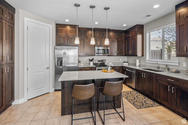 429 N 600 W, Moab, UT 84532 - kitchen featuring a kitchen island, light tile patterned floors, a sink, and stainless steel appliances