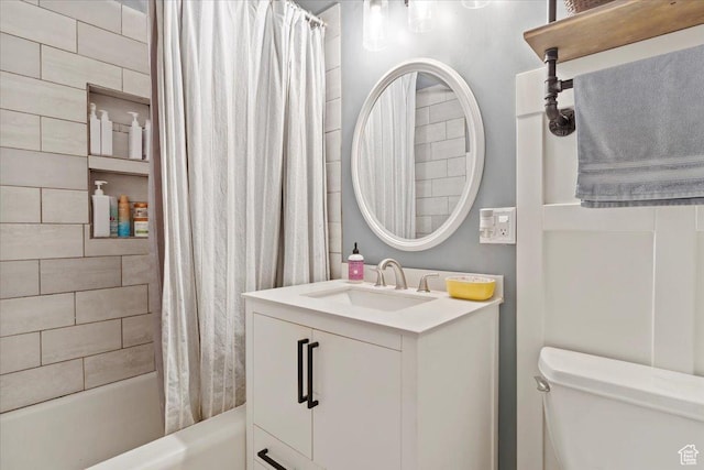 full bathroom with toilet, shower / bath combo with shower curtain, and vanity
