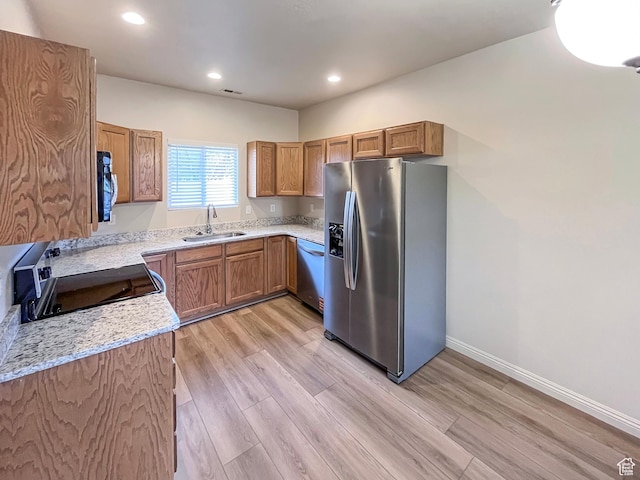 5262 W Cool Water Way, West Jordan, UT 84081 - kitchen featuring recessed lighting, light wood-type flooring, a sink, appliances with stainless steel finishes, and brown cabinets