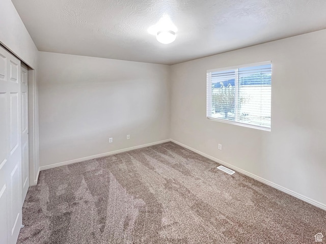 5262 W Cool Water Way, West Jordan, UT 84081 - unfurnished bedroom featuring baseboards, visible vents, a closet, and carpet flooring