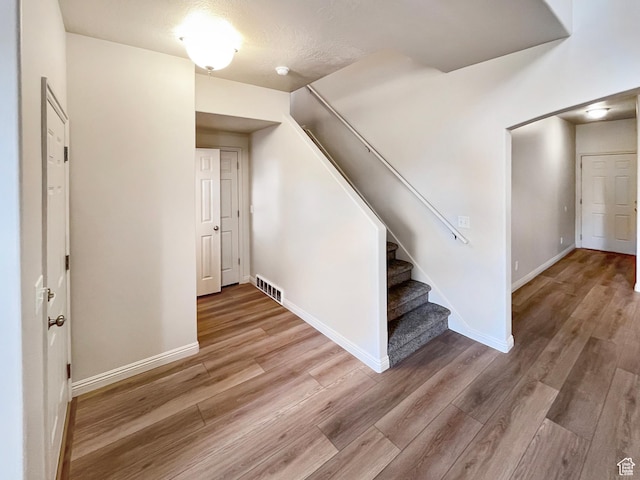 5262 W Cool Water Way, West Jordan, UT 84081 - interior space featuring baseboards, visible vents, and wood finished floors