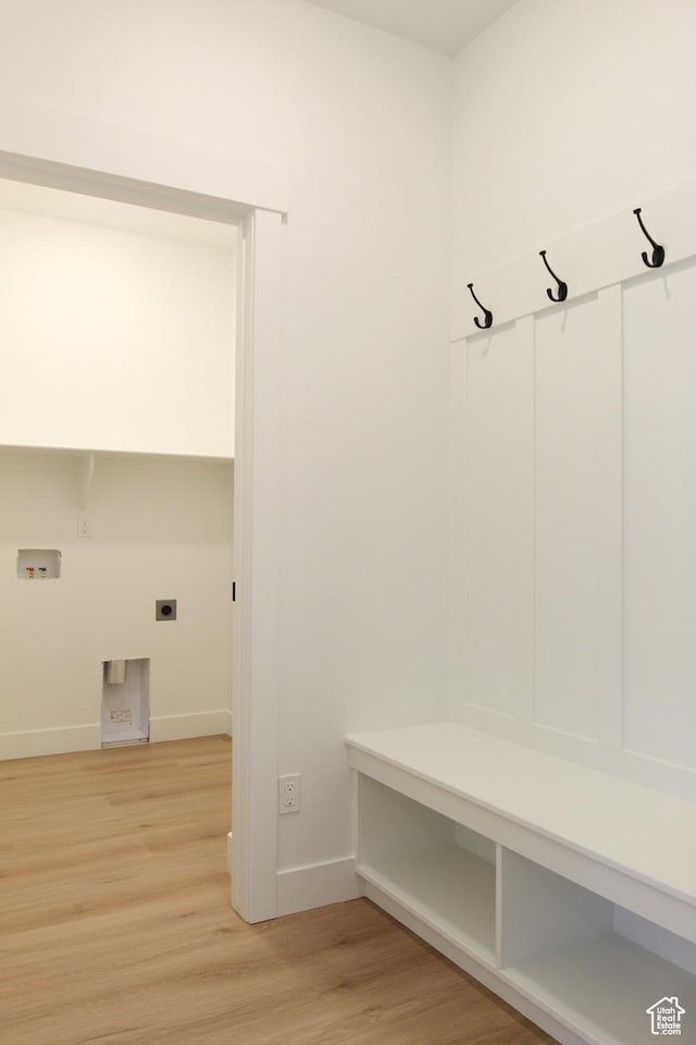 mudroom with light wood-style floors and baseboards