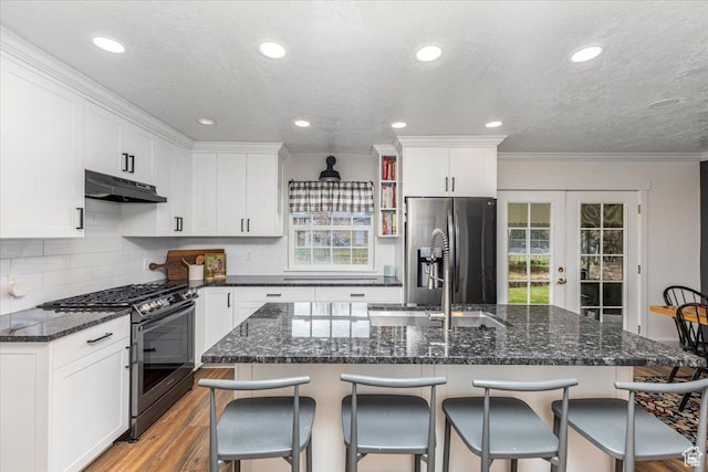 kitchen featuring french doors, light wood-style flooring, under cabinet range hood, stainless steel appliances, and white cabinets