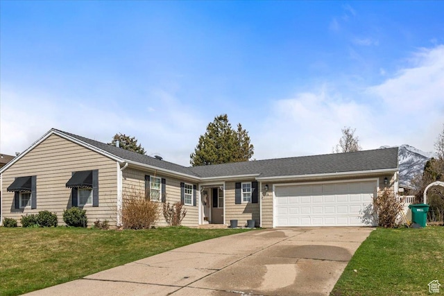 single story home with a front lawn, a garage, and concrete driveway