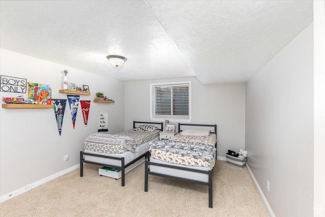 bedroom featuring baseboards, carpet flooring, and a textured ceiling