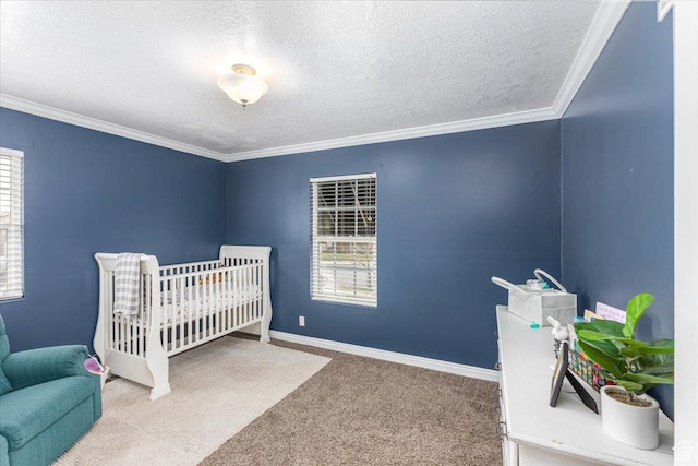 carpeted bedroom featuring baseboards, a textured ceiling, a crib, and crown molding