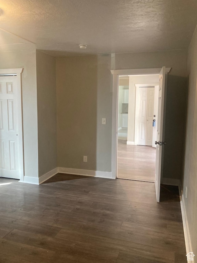 2855 Lincoln Ave, Ogden, UT 84401 - empty room with baseboards, dark wood-style flooring, and a textured ceiling