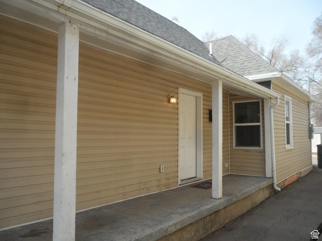 entrance to property with roof with shingles