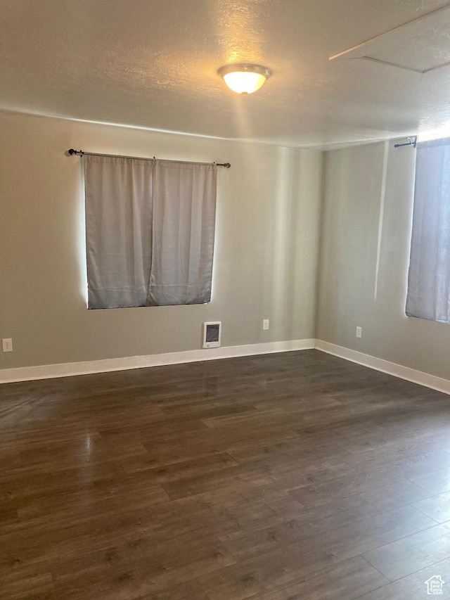 2855 Lincoln Ave, Ogden, UT 84401 - unfurnished room featuring dark wood-style floors, visible vents, baseboards, and a textured ceiling