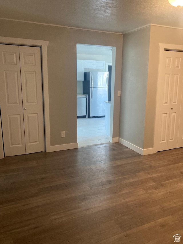 2855 Lincoln Ave, Ogden, UT 84401 - empty room with a textured ceiling, crown molding, baseboards, and dark wood-style flooring