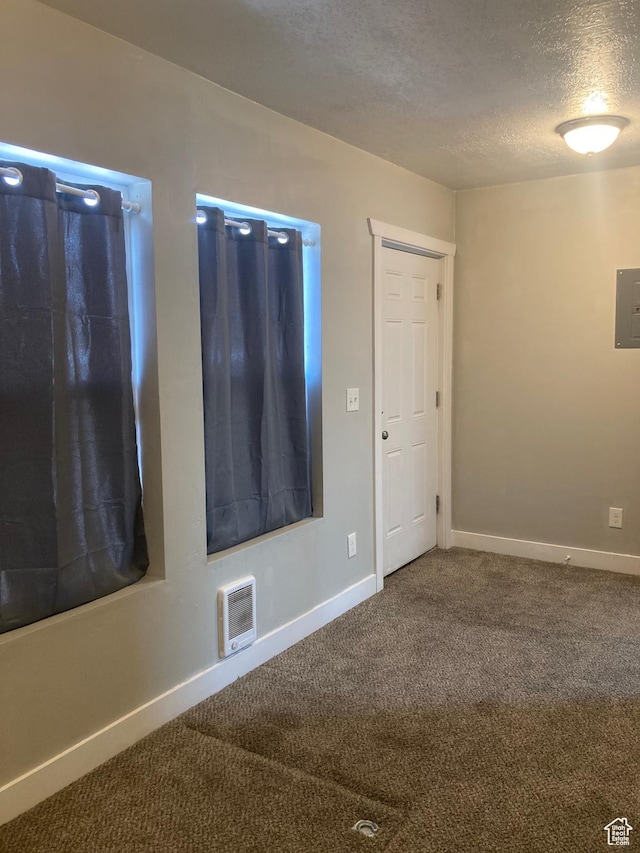2855 Lincoln Ave, Ogden, UT 84401 - carpeted spare room with electric panel, baseboards, and a textured ceiling