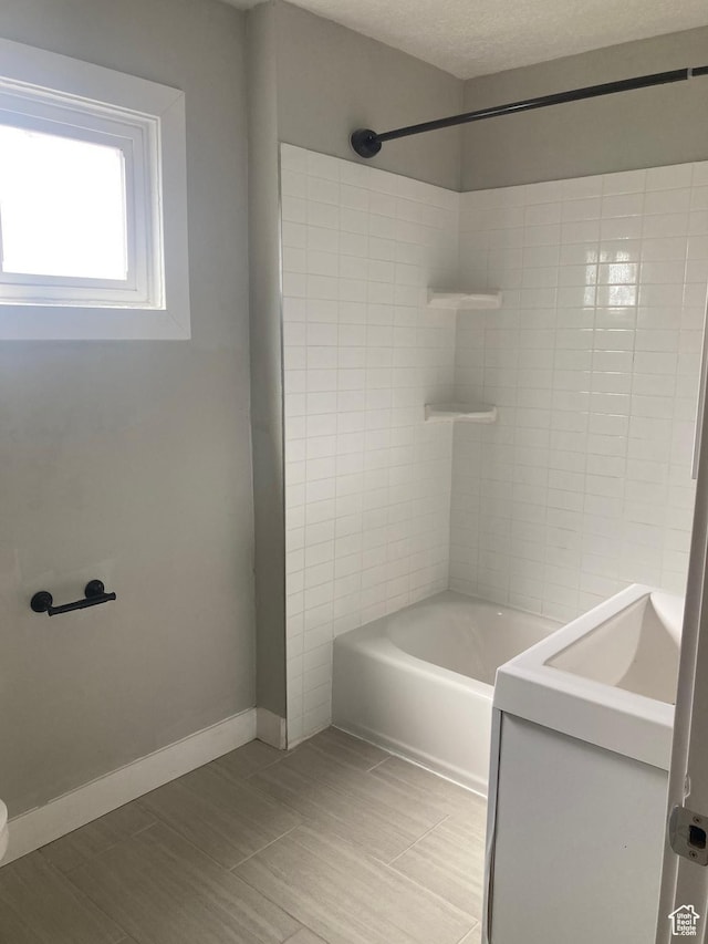 2855 Lincoln Ave, Ogden, UT 84401 - bathroom featuring shower / washtub combination, baseboards, and a textured ceiling