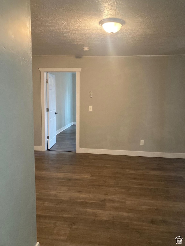 2855 Lincoln Ave, Ogden, UT 84401 - empty room featuring dark wood-style floors, baseboards, and a textured ceiling