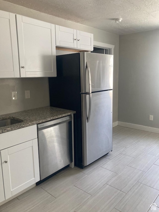 2855 Lincoln Ave, Ogden, UT 84401 - kitchen featuring white cabinets, a sink, and appliances with stainless steel finishes