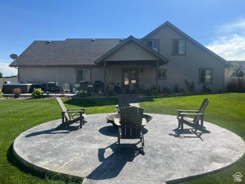 4190 W Delray N Unit 39, Vernal, UT 84078 - rear view of property featuring a patio, a yard, and stucco siding