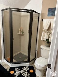 4190 W Delray N Unit 39, Vernal, UT 84078 - full bathroom featuring toilet, a shower stall, and baseboards