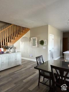 4190 W Delray N Unit 39, Vernal, UT 84078 - unfurnished dining area featuring baseboards, arched walkways, wood finished floors, and stairs