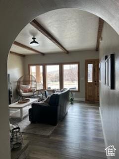 4190 W Delray N Unit 39, Vernal, UT 84078 - living area featuring arched walkways, beamed ceiling, baseboards, and a wealth of natural light