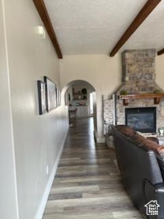 4190 W Delray N Unit 39, Vernal, UT 84078 - corridor featuring beamed ceiling, baseboards, arched walkways, and wood finished floors