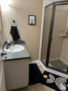 4190 W Delray N Unit 39, Vernal, UT 84078 - bathroom featuring baseboards, vanity, and a stall shower