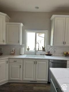 4190 W Delray N Unit 39, Vernal, UT 84078 - kitchen featuring white cabinets, a sink, dark wood-style flooring, light countertops, and backsplash