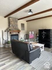 4190 W Delray N Unit 39, Vernal, UT 84078 - living area with a fireplace, beam ceiling, and wood finished floors