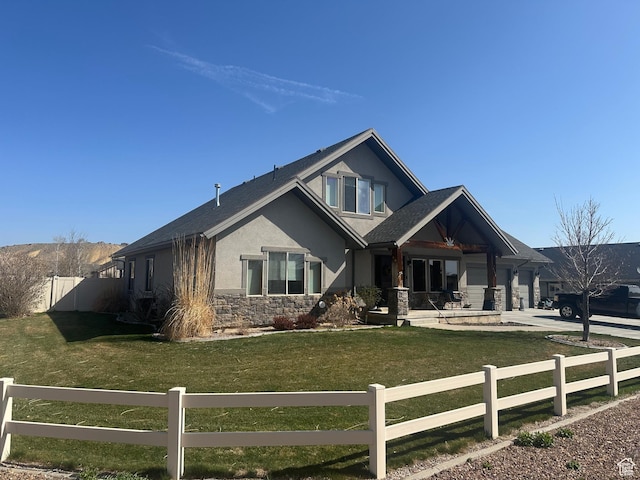 4190 W Delray N Unit 39, Vernal, UT 84078 - craftsman house featuring concrete driveway, stucco siding, stone siding, a fenced front yard, and a front yard