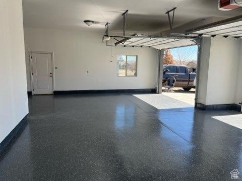 4190 W Delray N Unit 39, Vernal, UT 84078 - garage featuring baseboards and a garage door opener
