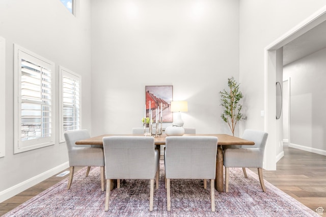 86 E 1675 S, Farmington, UT 84025 - dining room with baseboards, visible vents, a towering ceiling, and wood finished floors