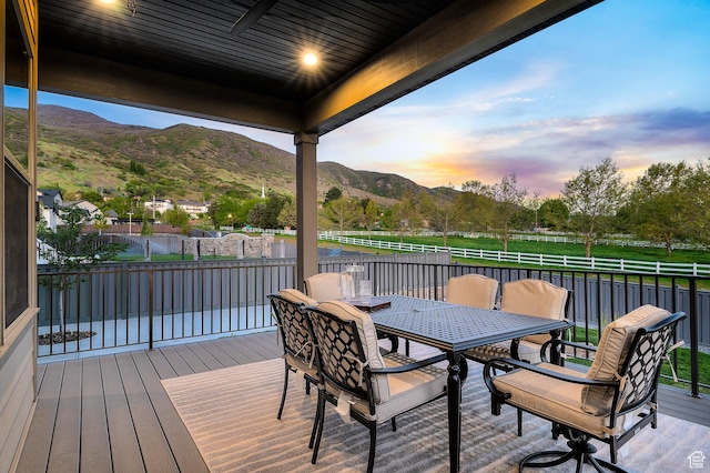 86 E 1675 S, Farmington, UT 84025 - deck at dusk with a mountain view, outdoor dining area, and fence