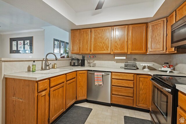 1077 E Deerwalk Ln S, Ogden, UT 84404 - kitchen featuring light countertops, a peninsula, brown cabinets, appliances with stainless steel finishes, and a sink
