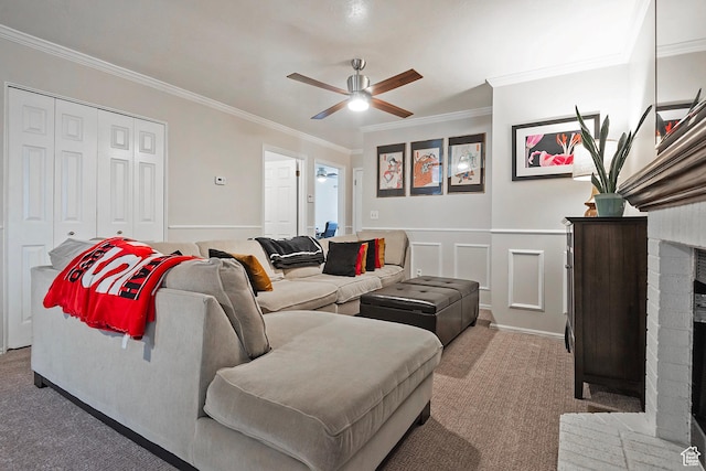 1077 E Deerwalk Ln S, Ogden, UT 84404 - carpeted living room with a decorative wall, crown molding, a brick fireplace, a ceiling fan, and wainscoting