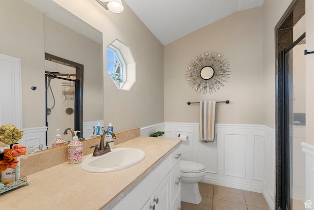 6832 W 1500 N, Cedar City, UT 84721 - bathroom featuring a stall shower, tile patterned floors, toilet, vanity, and wainscoting