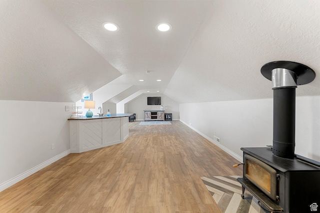 6832 W 1500 N, Cedar City, UT 84721 - bonus room featuring light wood finished floors, a textured ceiling, lofted ceiling, baseboards, and visible vents