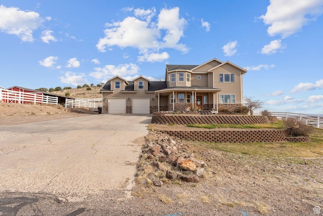 6832 W 1500 N, Cedar City, UT 84721 - traditional-style home with driveway, covered porch, stone siding, fence, and a garage