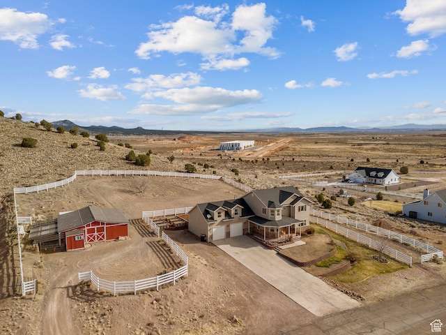 bird's eye view featuring a mountain view, a desert view, and a rural view