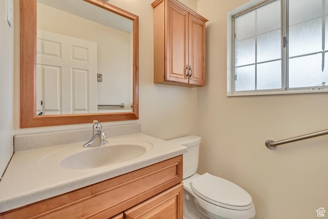 bathroom with toilet and vanity