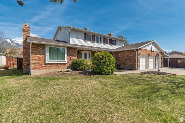 traditional-style home featuring concrete driveway, an attached garage, fence, and a chimney