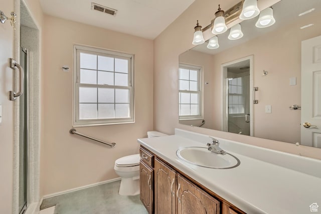 bathroom featuring a shower stall, vanity, visible vents, and toilet